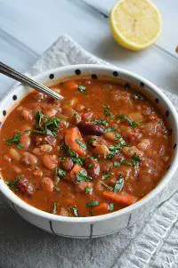 vegetarian 15 bean soup in a white bowl with a spoon