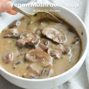 Vegan mushroom soup no cream in a white bowl with a spoon