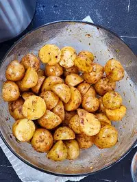 seasoned baby gold potatoes in a clear glass bowl