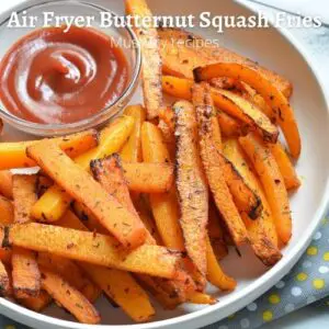 air fryer butternut squash fries in a plate served with ketchup