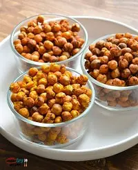 3 flavors of air fryer chickpeas in clear bowls on a white plate