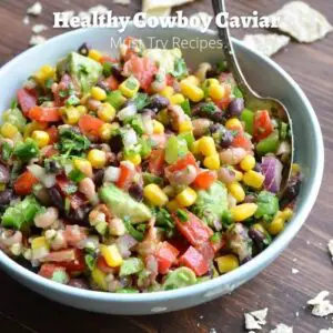 healthy cowboy caviar in a light blue bowl with a spoon