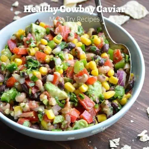 healthy cowboy caviar in a light blue bowl with a spoon