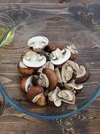 halved mushrooms in a clear bowl