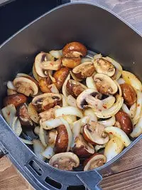 seasoned mushrooms and onions in air fryer basket