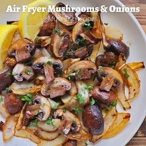 air fryer mushrooms and onions in a white plate served with lemon wedges