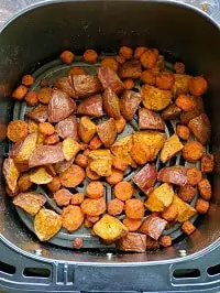 roasted potatoes and carrots in air fryer basket