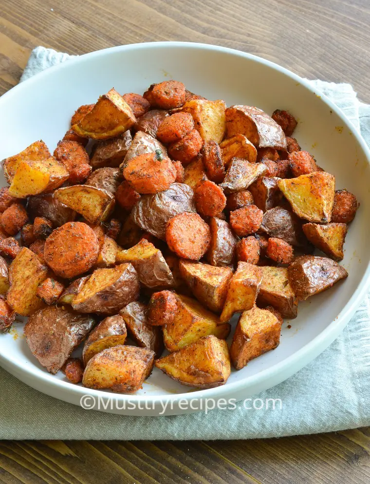 air fryer carrots and potatoes on a white plate