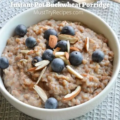instant pot buckwheat porridge in a white bowl garnished with whole blueberries and silvered almonds
