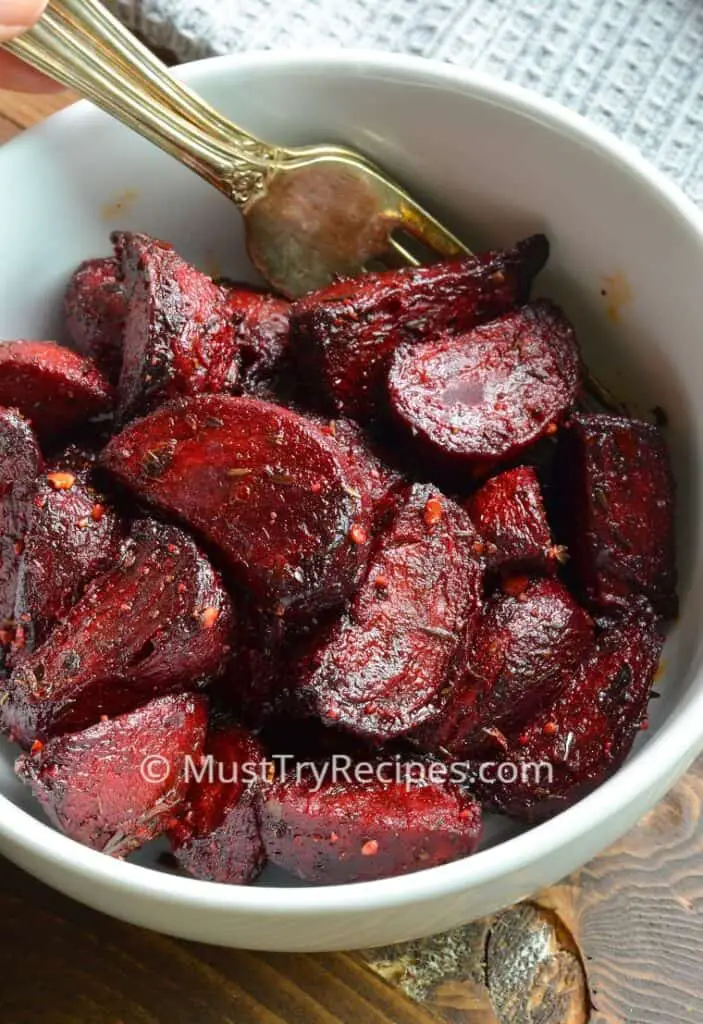 air fryer beets in a white bowl with a pair of forks
