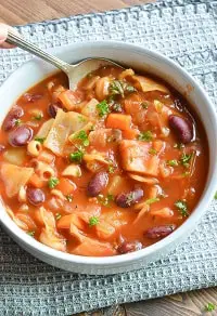 portuguese bean soup in a white bowl with a spoon