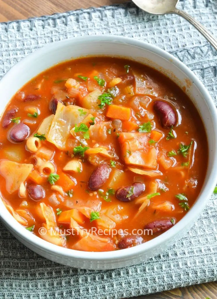 vegan Portuguese bean soup in a white bowl 