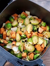 sweet potatoes and brussel sprouts in air fryer basket