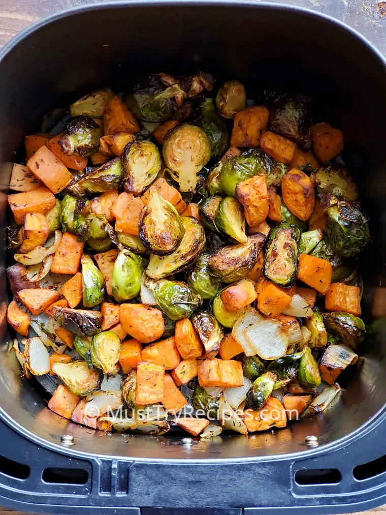 roasted brussel sprouts and sweet potatoes in air fryer basket
