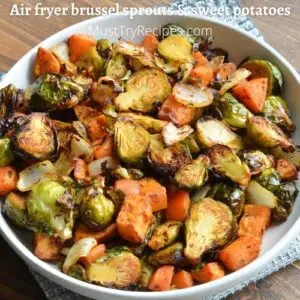 air fryer brussel sprouts and sweet potatoes in a white plate
