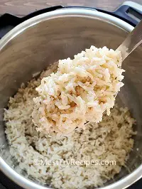 fluffy coconut brown basmati rice in a steel ladle