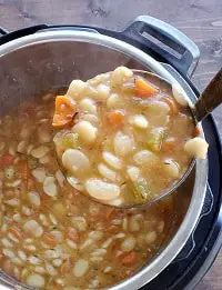 cooked lima beans soup in a ladle