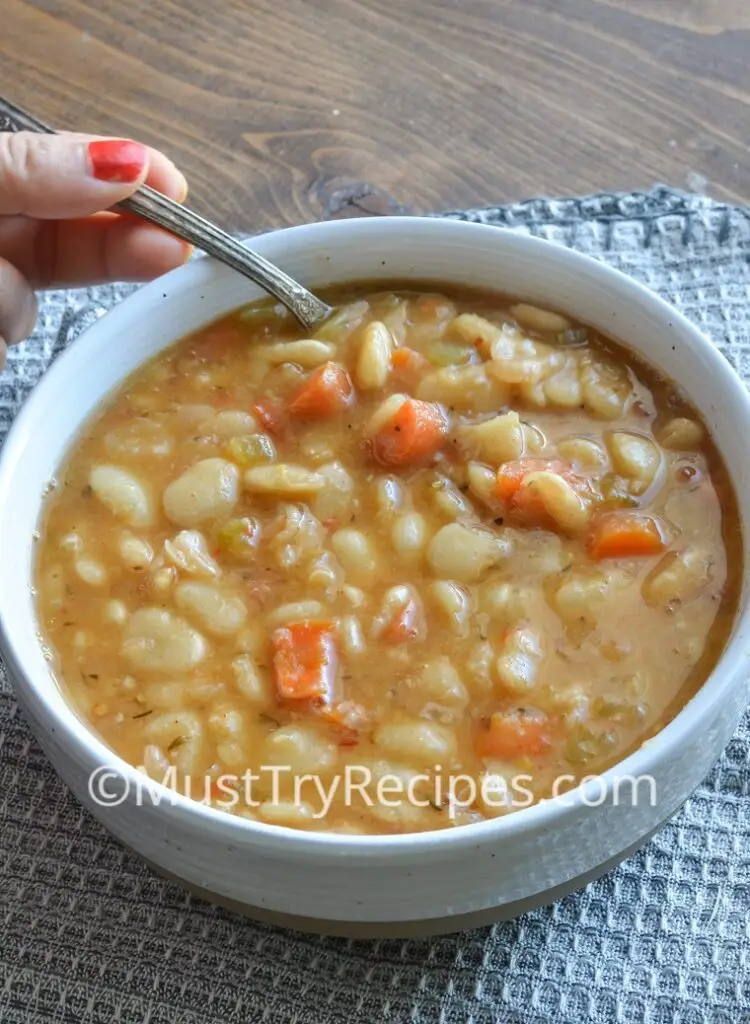 instant pot lima beans in a white bowl with a spoon
