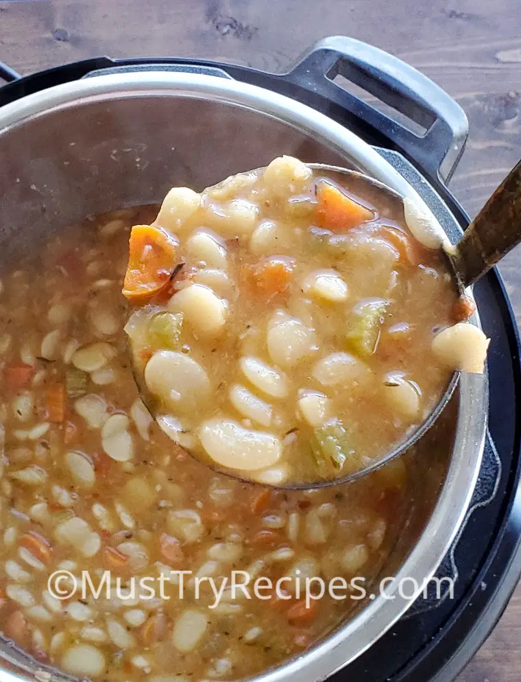 cooked dry lima beans in instant pot in a ladle