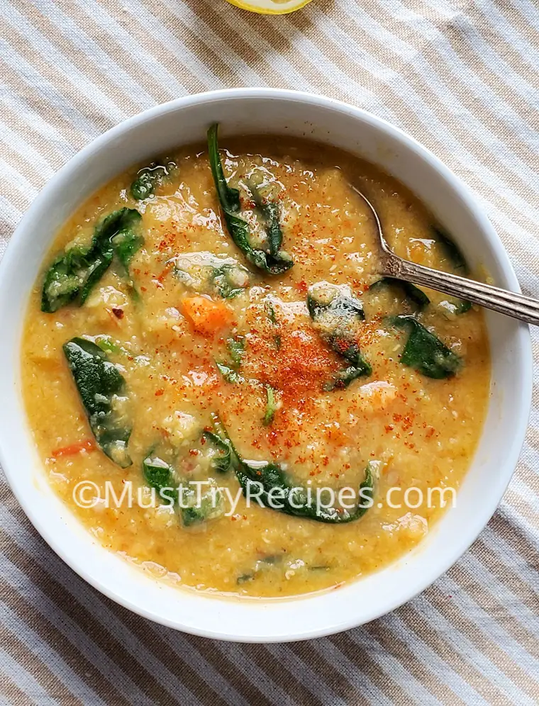 easy red lentil soup in a white bowl with a spoon