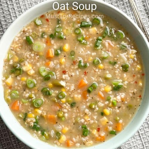 oat soup with vegetables in a pale blue bowl