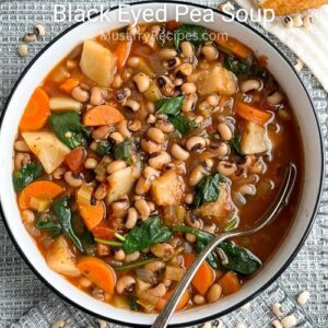 vegetarian black eyed pea soup in a white bowl with a spoon