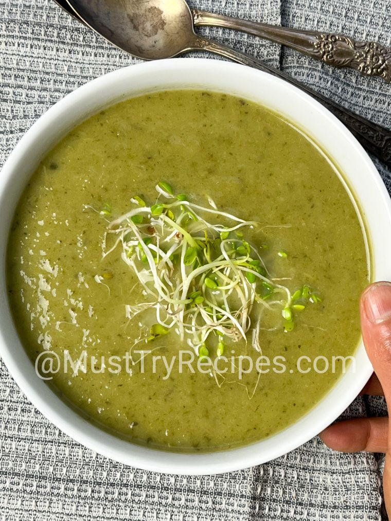 simple lettuce soup served in a white bowl and garnished with microgreens