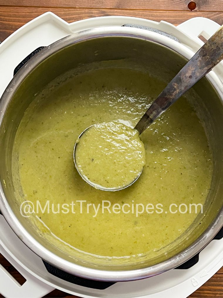 pureed lettuce soup in the instant pot with a silver ladle