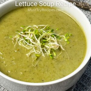 lettuce soup in a white bowl garnished with microgreens