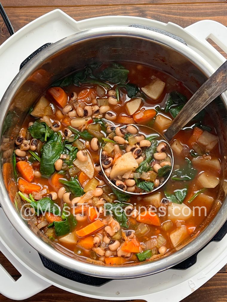 vegetarian black eyed pea soup in instant pot with a silver ladle.