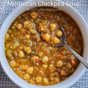 Moroccan chickpea soup served in a white bowl with a spoon